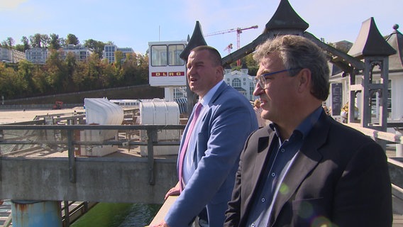 Rügener Kommunalpolitiker stehen auf der Seebrücke in Sellin. © NDR Foto: Screenshot