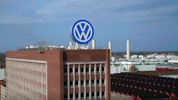 Ein großes Gebäude mit großem VW-Logo auf dem Dach  