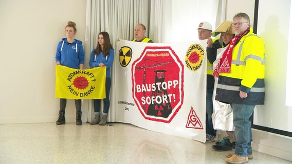Menschen protestieren mit Plakaten gegen das Atommüll-Endlager Schacht Konrad. © NDR 