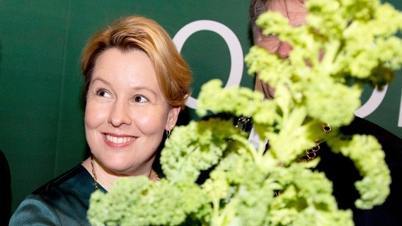 Bundesfamilienministerin Franziska Giffey (SPD) hält einen großen Grünkohl in der Hand bei ihrer Ernennung zur Oldenburger Grünkohlkönigin. © dpa - Bildfunk Foto: Christoph Soeder