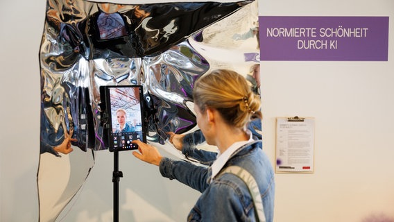 Eine Frau schießt ein Foto mit einem Tablet in einer Fotobox. © Museum Industriekultur Osnabrück 