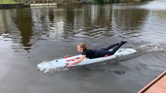 Janka Krohn liegt auf einem Rettungsboard auf dem Wasser © NDR Foto: Lena Haamann