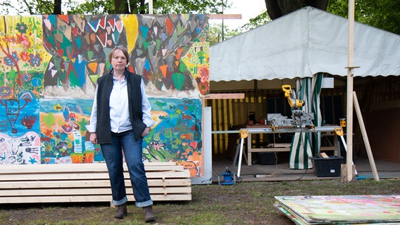 Maike Wiechmann steht vor einer bunt bemalten Wand. © NDR Foto: Lisa Pandelaki
