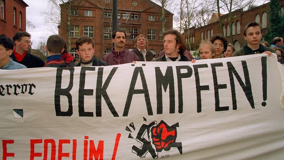 Nach dem Anschlag versammeln sich am 26. März 1994 Menschen zu einer Protestkundgebung in Lübeck. © Picture-Alliance/dpa Foto: Stefan Hesse