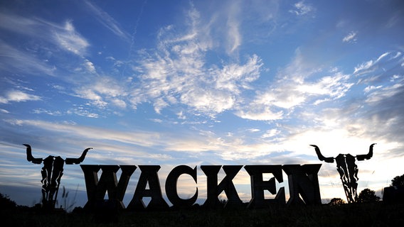 Die Schriftzeichen Wacken vor einem wolkigen Himmel © dpa Bildfunk Foto: Daniel Reinhardt