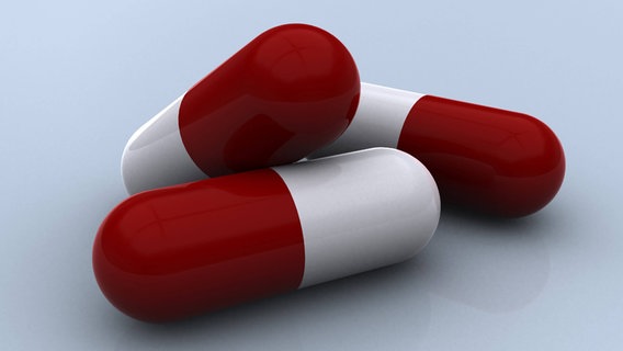 Drei rot-weiße Tabletten. © StockTrek Images 