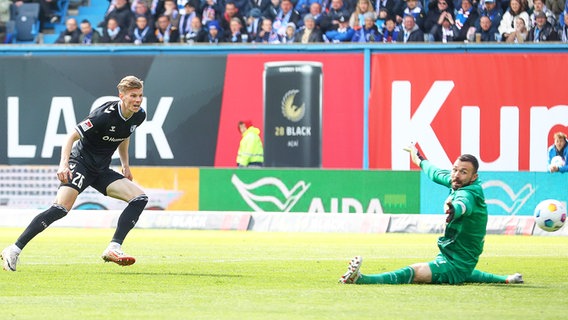 Rostocks Torhüter Markus Kolke (r.) kann einen Treffer von Magdeburgs Luca Schuler nicht verhindern. © IMAGO / Jan Huebner 