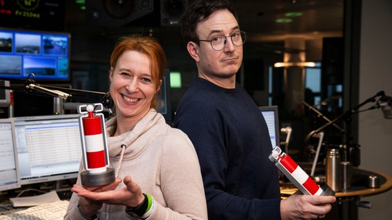 Das Moderatorenduo Mandy Schmidt und Horst Hoof posieren mit der "Leuchte des Nordens", die Horst in der Quizshow gewann. © NDR Foto: Dominik Dührsen